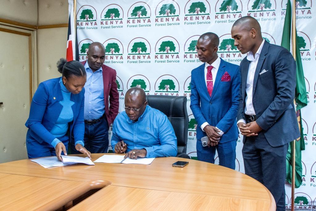Signing agreement by Honourable Owen Yaa Baya, Deputy Majority Leader of the Kenyan Parliament and Member of Parliament for Kilifi North, representing Mikoko Initiative